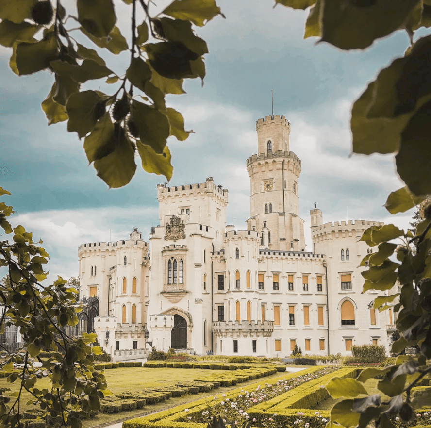 A castle in the countryside with a garden